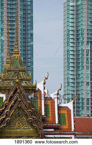Stock Image - Small Temple And Modern Tower Blocks In Bangkok. Fotosearch