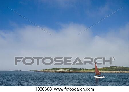 Stock Photo - Small Traditional Sailing Boat In Estuary. Fotosearch