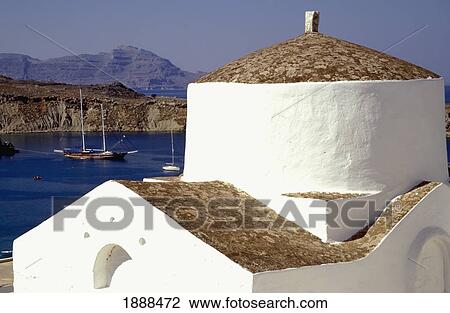 Stock Image - Small Whitewashed Chapel By Coast In Lindos. Fotosearch