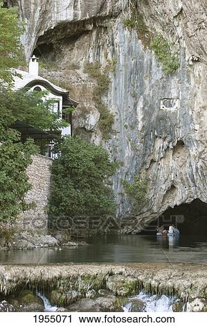 Stock Image - Small Zodiac On The Buna River Going Into The Cave, Blagaj, Herzegovina-Neretva, Bosnia And Herzegovina. Fotosearch