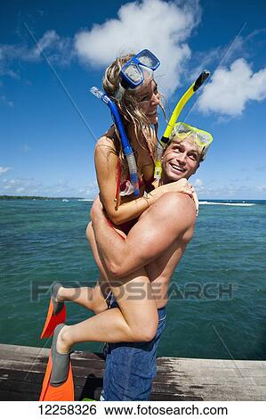 Stock Photograph - Snorkelers playing and having fun; Uplolu Island, Samoa. Fotosearch
