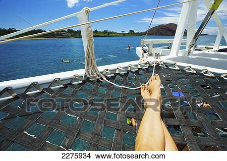 Picture - Snorkelling, swimming and relaxing on a catamaran off the coast of an hawaiian island; Hawaii, United States of America. Fotosearch