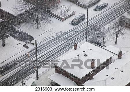Stock Image - Snow And Tire Tracks On Road; Toronto Canada. Fotosearch