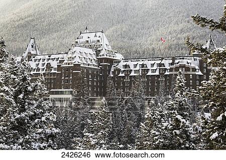 Snow covered Banff Springs Hotel with snow covered trees and a Canadian flag; Banff, Alberta, Canada View Large Photo Image Stock Photograph - Snow covered Banff Springs Hotel with snow covered trees and a Canadian flag; Banff, Alberta, Canada. Fotosearch