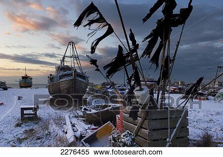 Stock Photography - Snow covered fishing boats and nets, Old Town; Hastings, East Sussex, England. Fotosearch
