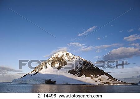 Stock Photograph - Snow Covered Mountain On The Coast; Antarctica. Fotosearch