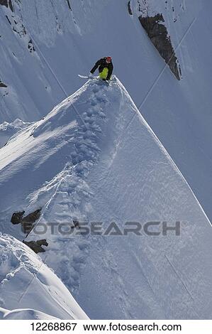 Snowboarder balancing on extreme mountain ridge; Methven, New Zealand View Large Photo Image Stock Photo - Snowboarder balancing on extreme mountain ridge; Methven, New Zealand. Fotosearch