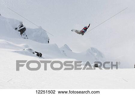 Snowboarder jumping; Patagonia, Argentina View Large Photo Image Stock Image - Snowboarder jumping; Patagonia, Argentina. Fotosearch