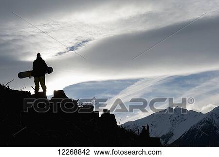 Snowboarder silhouetted on a mountain, Methven, New Zealand View Large Photo Image Stock Image - Snowboarder silhouetted on a mountain, Methven, New Zealand. Fotosearch