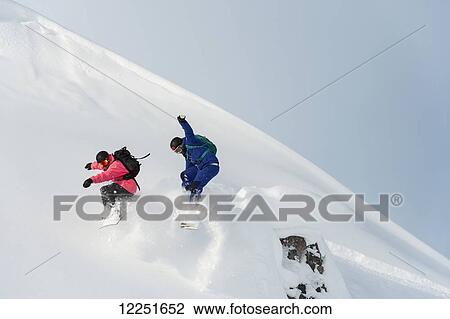 Stock Image - Snowboarding in powder snow; St. Moritz, Graubunden, Switzerland. Fotosearch