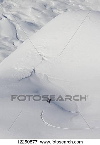 Stock Photo - Snowboarding on a snow covered slope; Haines, Alaska, United States of America. Fotosearch