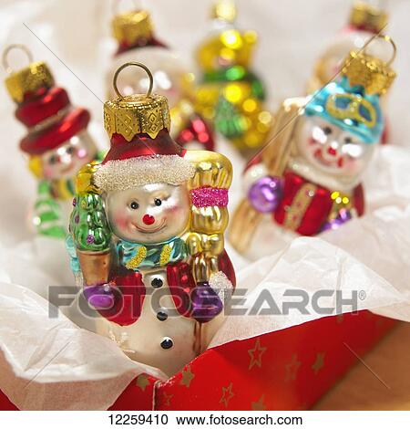 Snowmen Christmas ornaments in a red box with tissue; Victoria, British Columbia, Canada View Large Photo Image Stock Image - Snowmen Christmas ornaments in a red box with tissue; Victoria, British Columbia, Canada. Fotosearch