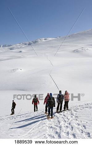 Stock Photo - Snowshoeing At Grimsel Pass Which Offers Fantastic Views Over The Goms Valley.. Fotosearch