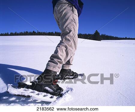 Stock Image - Snowshoeing- Close Up Of Boots. Jura Mountains. Franche Comt. Fotosearch