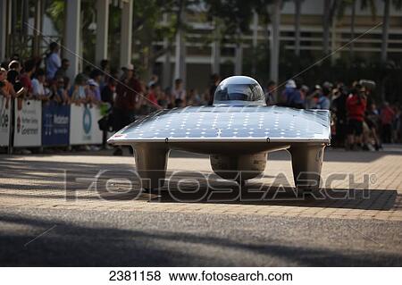 Stock Photo - Solar car departing on the road; Darwin, Australia. Fotosearch