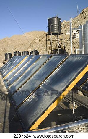 Picture - Solar panels used to heat water at a guesthouse in Leh. Leh was the capital of the Himalayan kingdom of Ladakh, now the Leh District in the state of Jammu and Kashmir, India. Leh is at an altitude of 3, 500 meters (11, 483 ft).. Fotosearch