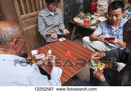 Some Hakka people playing traditional Chinese cards; Yongding, Fujian province. China View Large Photo Image Stock Photo - Some Hakka people playing traditional Chinese cards; Yongding, Fujian province. China. Fotosearch