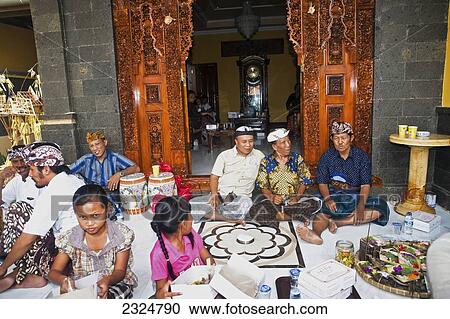 Stock Image - Some Local Elders Wait Outside Of A New Religious Ceremony, Pemogan, Bali, Indonesia. Fotosearch