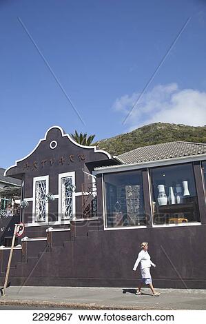 Stock Photo - South Africa, Cape Town, View Of Street With Shop And Passing Tourist; Kalk Bay. Fotosearch