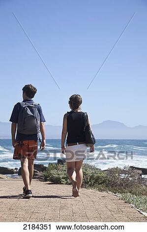 Stock Image - South Africa, Couple On Path At Pinnacle Point; Mossel Bay. Fotosearch