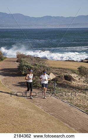 South Africa, Couple Running Along Shore; Mossel Bay View Large Photo Image Stock Image - South Africa, Couple Running Along Shore; Mossel Bay. Fotosearch