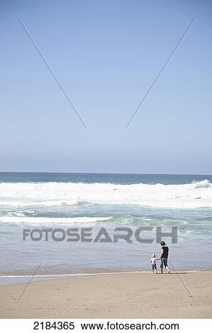 Stock Photography - South Africa, Distant View; Mossel Bay, Mother And Daughter At Seaside. Fotosearch