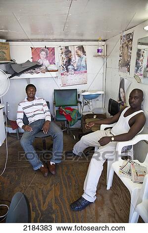 Stock Image - South Africa, Garden Route, Barbers Waiting In Hair Salon; Port Elizabeth. Fotosearch