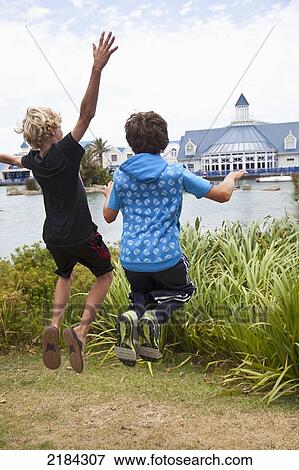 South Africa, Garden Route, Boardwalk Shopping Mall In Background; Port Elizabeth, Boys Jumping In Air View Large Photo Image Stock Photo - South Africa, Garden Route, Boardwalk Shopping Mall In Background; Port Elizabeth, Boys Jumping In Air. Fotosearch