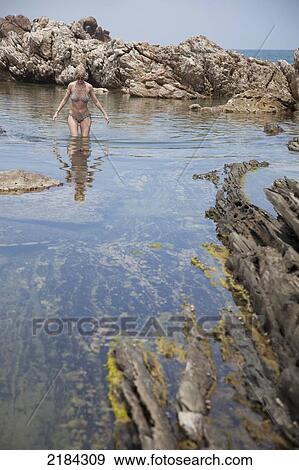 Stock Photo - South Africa, Garden Route, Bushy Park Coastal Area; Port Elizabeth, Woman At Rockpool. Fotosearch