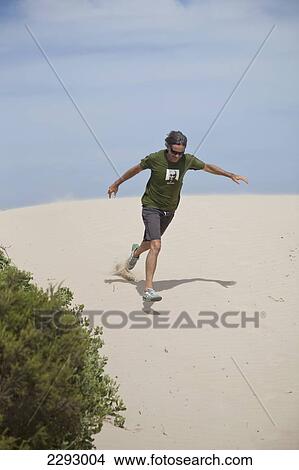 South Africa, Garden Route, Man Running Down Sand Dune; St Francis Bay View Large Photo Image Picture - South Africa, Garden Route, Man Running Down Sand Dune; St Francis Bay. Fotosearch