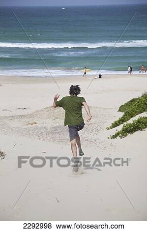 South Africa, Garden Route, Man Running Down Sand Dune; St Francis Bay View Large Photo Image Stock Photo - South Africa, Garden Route, Man Running Down Sand Dune; St Francis Bay. Fotosearch