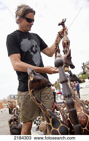 South Africa, Garden Route, Man Shopping For Local Handicrafts; Port Elizabeth View Large Photo Image Stock Image - South Africa, Garden Route, Man Shopping For Local Handicrafts; Port Elizabeth. Fotosearch