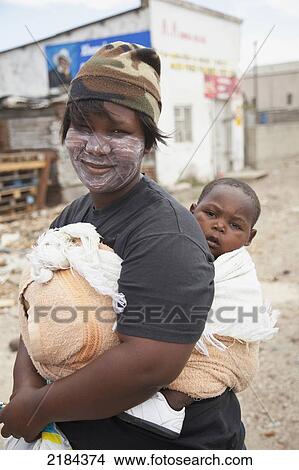 South Africa, Garden Route, Port Elizabeth, Portrait Of Woman Carrying Her Son; New Brighton View Large Photo Image Picture - South Africa, Garden Route, Port Elizabeth, Portrait Of Woman Carrying Her Son; New Brighton. Fotosearch