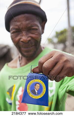 Stock Photo - South Africa, Garden Route, Port Elizabeth, Portrait Of Mature Man With Bell; New Brighton. Fotosearch