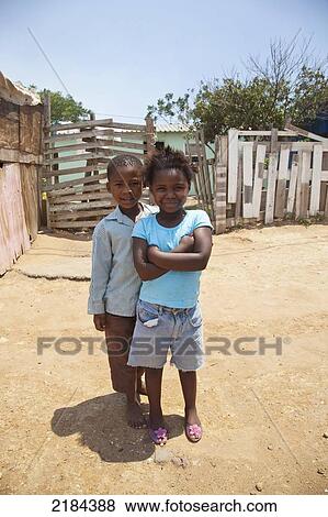 Stock Photo - South Africa, Garden Route, Port Elizabeth, Portrait Of Boy And Girl At Street; New Brighton. Fotosearch