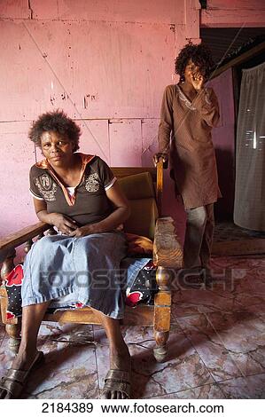 Stock Photo - South Africa, Garden Route, Port Elizabeth, Portrait Of Two Women Indoors; New Brighton. Fotosearch