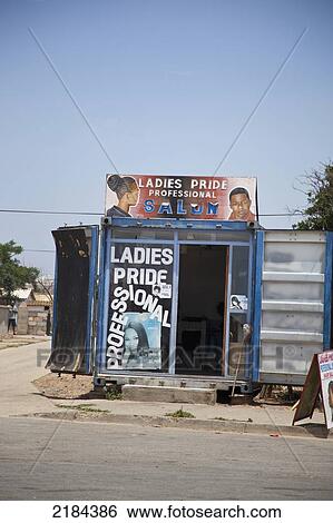 Stock Photograph - South Africa, Garden Route, Port Elizabeth, Ladies Hairdresser Kiosk With Ads; New Brighton. Fotosearch