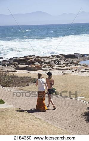 Stock Image - South Africa, Girls Walking On Path; Mossel Bay. Fotosearch