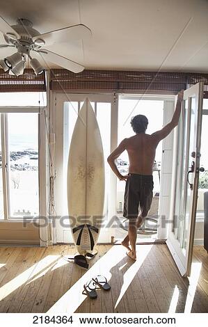 South Africa, Surfer With Surfboard In Doorway; Mossel Bay View Large Photo Image Picture - South Africa, Surfer With Surfboard In Doorway; Mossel Bay. Fotosearch