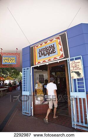 Stock Photo - South Africa, Tourist Entering Souvenir Store; Cape Town. Fotosearch