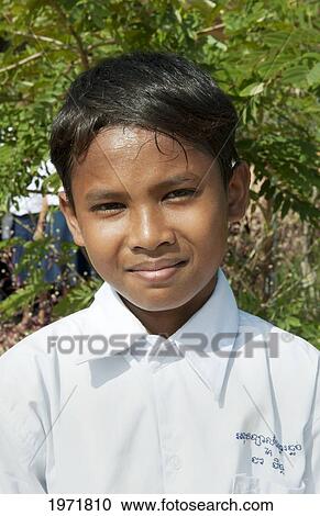 Stock Image - South East Asia, Cambodia, Siem Reap, A Young Boy Poses For A Picture During A Break From Class.. Fotosearch