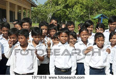Stock Photo - South East Asia, Cambodia, Siem Reap, A Group Of Young School Children Gather For A Class Photo.. Fotosearch