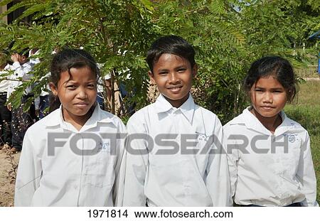 Picture - South East Asia, Cambodia, Siem Reap, Three Young School Children Pose For Their Picture.. Fotosearch
