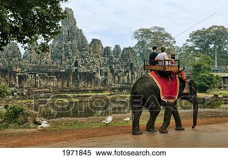 Stock Photography - South East Asia, Cambodia, Siem Reap, Tourists Take A Guided Elephant Ride To An Ancient Temple.. Fotosearch