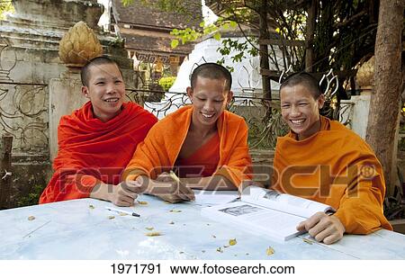 South East Asia, Laos, Luang Prabang, Three Young Monks Sudy In The Temple Garden. View Large Photo Image Stock Image - South East Asia, Laos, Luang Prabang, Three Young Monks Sudy In The Temple Garden.. Fotosearch