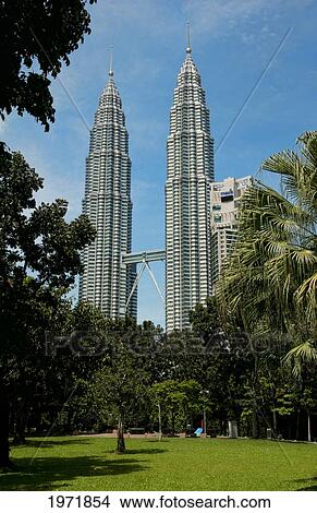 Picture - South East Asia, Malaysia, Kuala Lumpur, Gigantic Twin Towers Are Framed By Trees Over Park.. Fotosearch