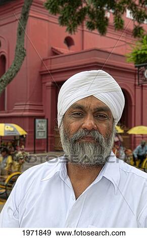 Stock Photo - South East Asia, Malaysia, Melaka Aka Heritage City, Portrait Of An Older Bearded Man In Main Square With Artists And Flower Vendors.. Fotosearch
