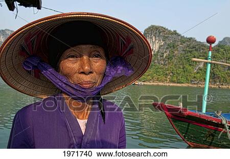South East Asia, Vietnam, Ha Long Bay, Portrait Of A Vietnamese Woman, Harbor In Background. View Large Photo Image Stock Image - South East Asia, Vietnam, Ha Long Bay, Portrait Of A Vietnamese Woman, Harbor In Background.. Fotosearch