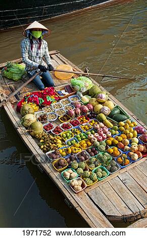 South East Asia, Vietnam, Ha Long Bay, Vietnamese Woman Sells Fresh Fruit From Her Small Boat. View Large Photo Image Stock Image - South East Asia, Vietnam, Ha Long Bay, Vietnamese Woman Sells Fresh Fruit From Her Small Boat.. Fotosearch