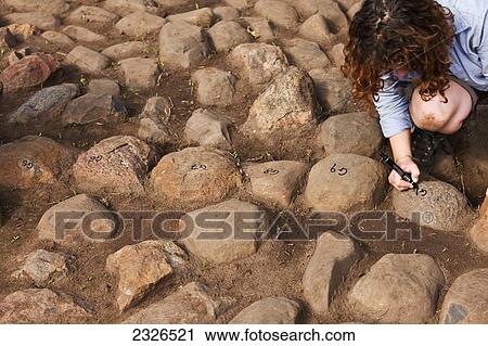 South Western Ethiopia, Omo Valley, Southern Mursiland, Woman writing numbers stones of first benna kulugto; Dirikoro View Large Photo Image Stock Image - South Western Ethiopia, Omo Valley, Southern Mursiland, Woman writing numbers stones of first benna kulugto; Dirikoro. Fotosearch